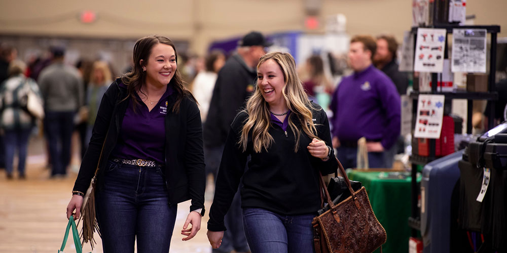 two students walking through job fair