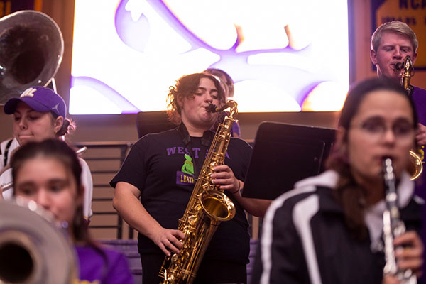 a handful of students performing in the pep band