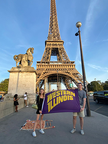 Students in Paris holding WIU banner