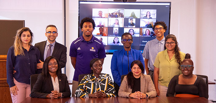 photo with students in the internship program along with a Zoom meeting in the background of other interns