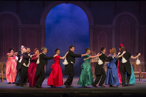 A line of party guests dancing.