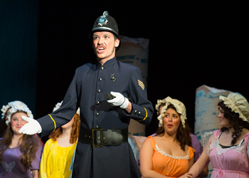 Man in police uniform singing.