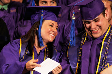 graduates with diplomas