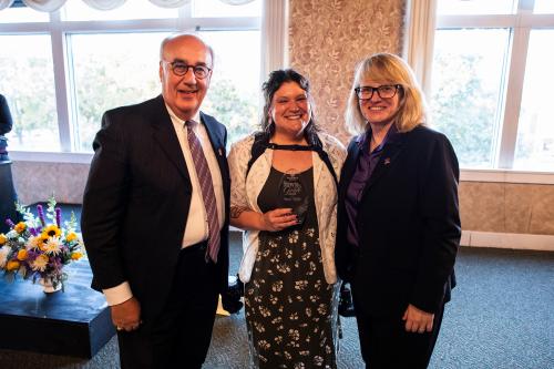 WIU Photography Lab Manager Sarah Ritter (middle) was presented with the 2025 Town & Gown award. Ritter stands between Macomb Mayor Mike Inman (left) and WIU President Kristi Mindrup (right).
