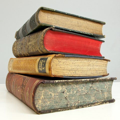 A stack of four old books